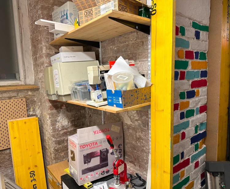 A button machine and a few sewing machines on a shelf