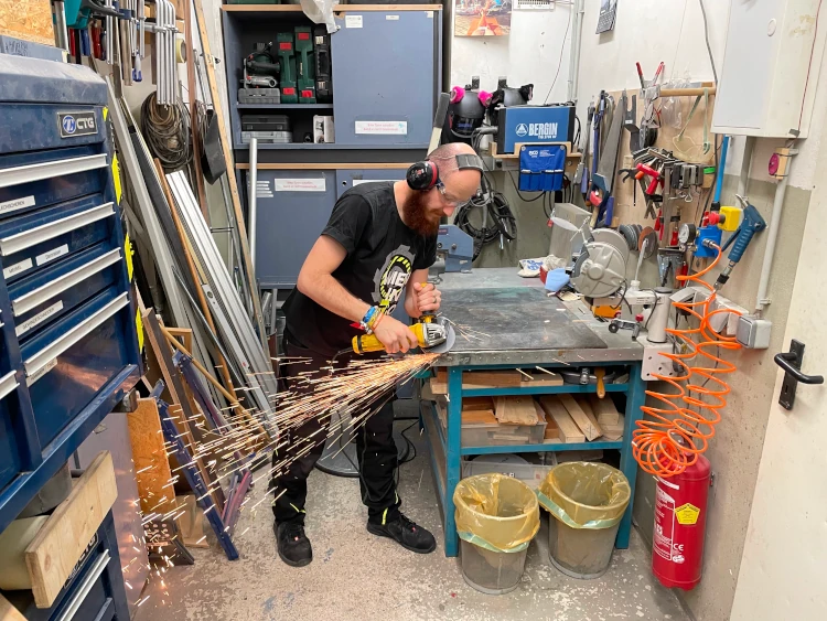 A Metalab member grinding metal with flying sparks